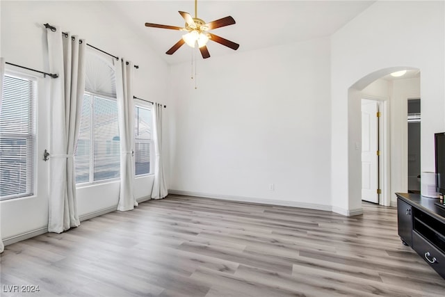 interior space with high vaulted ceiling, ceiling fan, and light hardwood / wood-style flooring