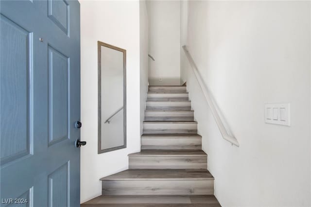 stairway featuring hardwood / wood-style flooring