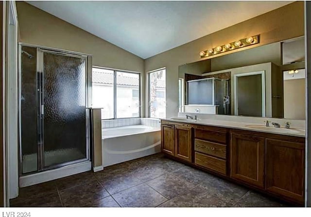 bathroom featuring tile patterned floors, vanity, independent shower and bath, and vaulted ceiling