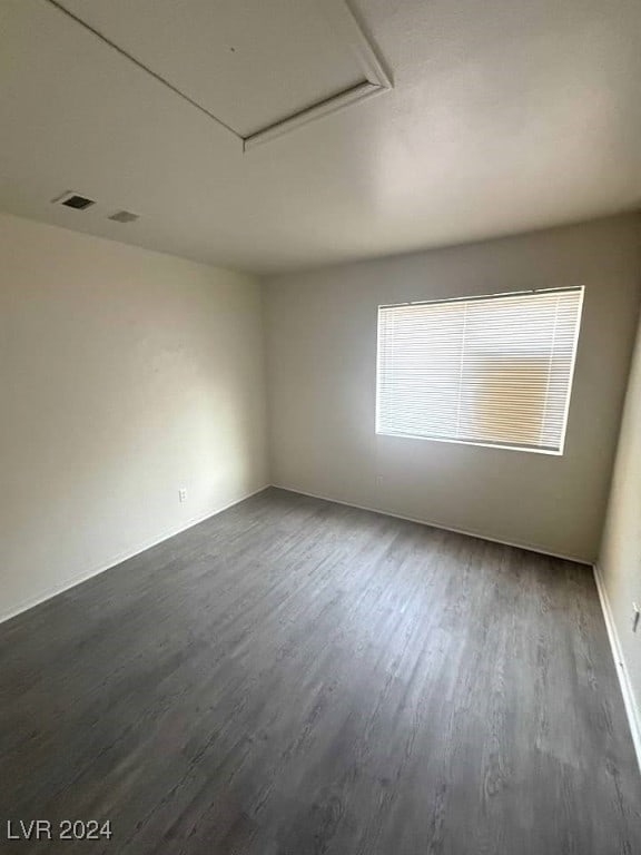 spare room with dark wood-type flooring