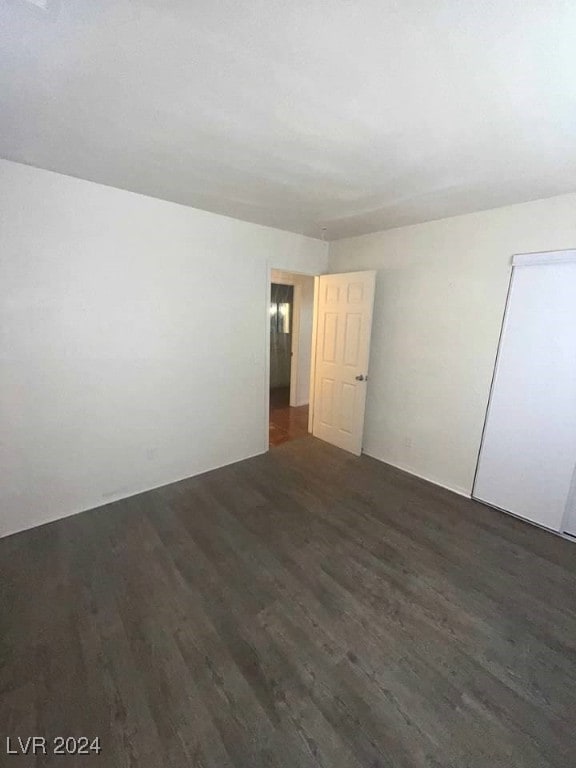 unfurnished room featuring dark wood-type flooring