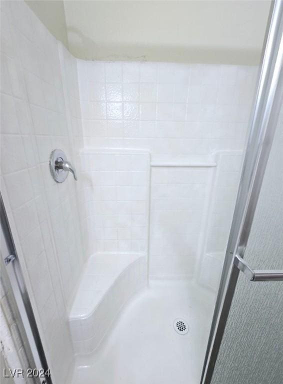 bathroom with a tile shower