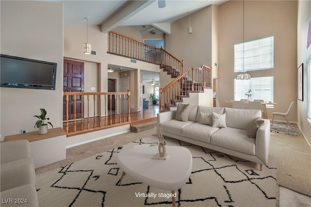 living room featuring beam ceiling, ceiling fan with notable chandelier, light colored carpet, and high vaulted ceiling