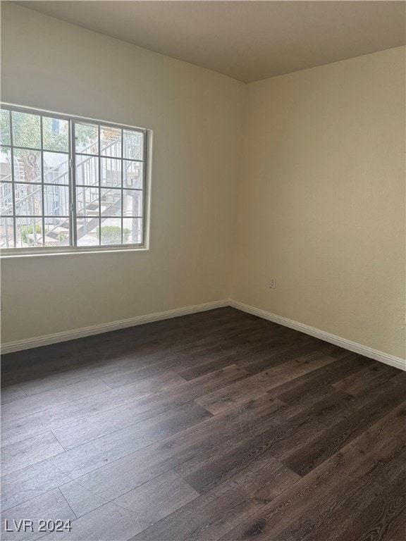 spare room with dark wood-type flooring