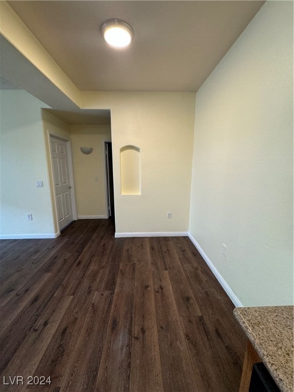 spare room with dark wood-type flooring