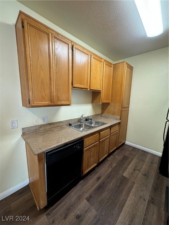 kitchen with dishwasher, dark wood-type flooring, sink, and a textured ceiling