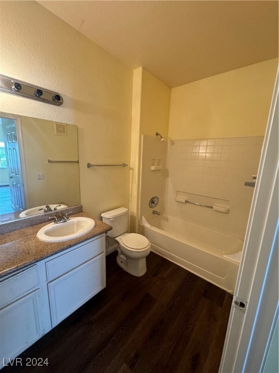 full bathroom featuring vanity, bathtub / shower combination, toilet, and hardwood / wood-style flooring