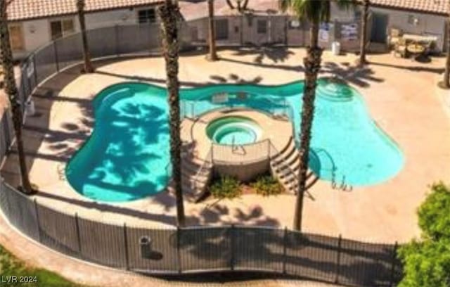 view of pool featuring a patio area and a hot tub