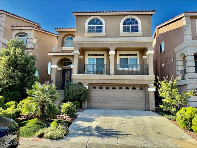 mediterranean / spanish-style house with a garage