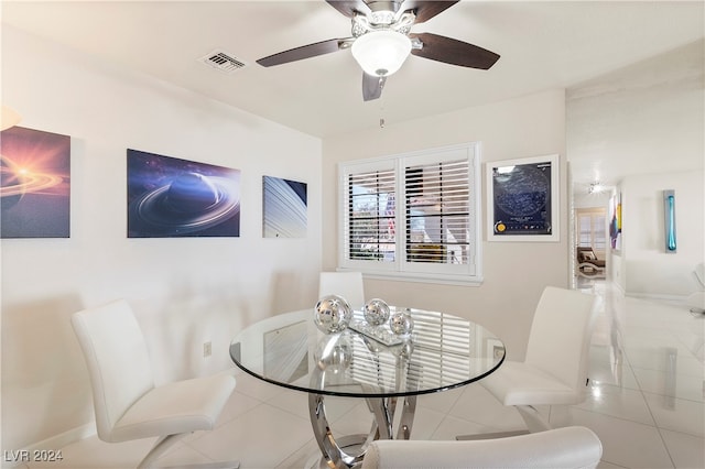 dining space featuring ceiling fan and light tile patterned floors