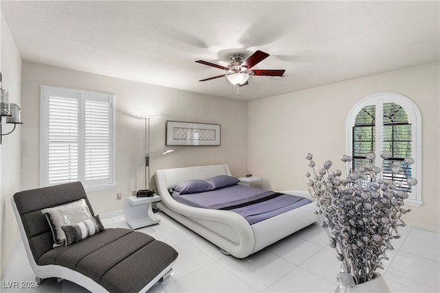 bedroom with ceiling fan and light tile patterned flooring