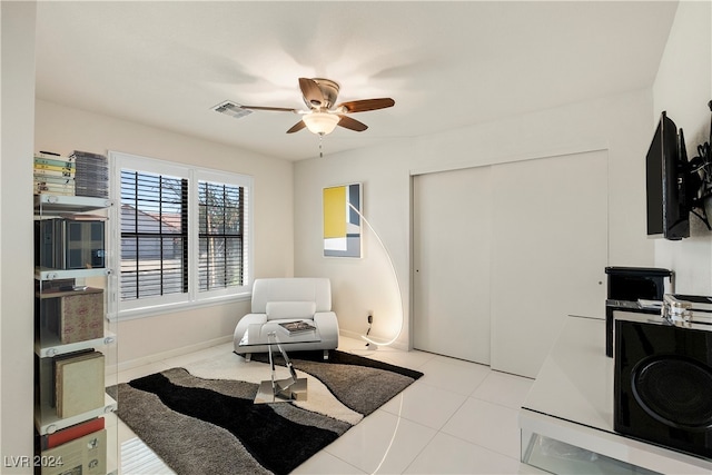 interior space with ceiling fan