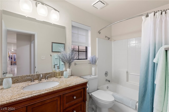 full bathroom with shower / tub combo, toilet, and vanity