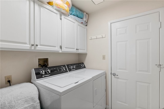 clothes washing area featuring cabinets and independent washer and dryer