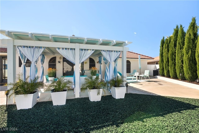 back of house with a pergola and a patio area