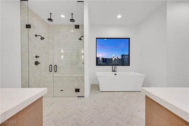 bathroom with vanity and separate shower and tub