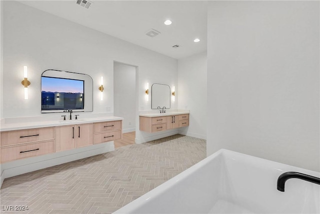 bathroom with vanity and a tub