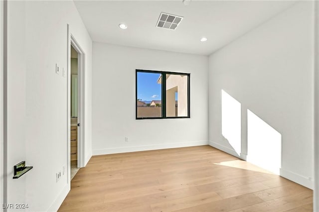 unfurnished room with light hardwood / wood-style floors