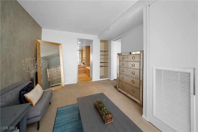 living area featuring carpet flooring and baseboards