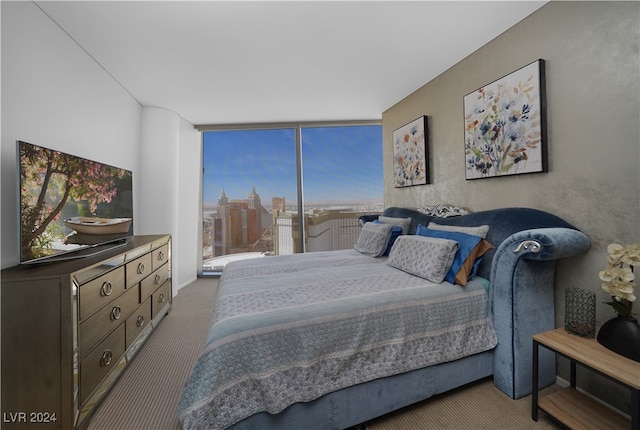 carpeted bedroom with a wall of windows