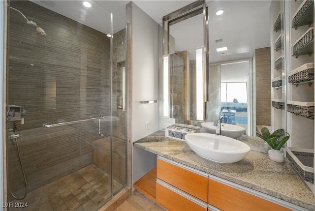 bathroom featuring walk in shower and vanity