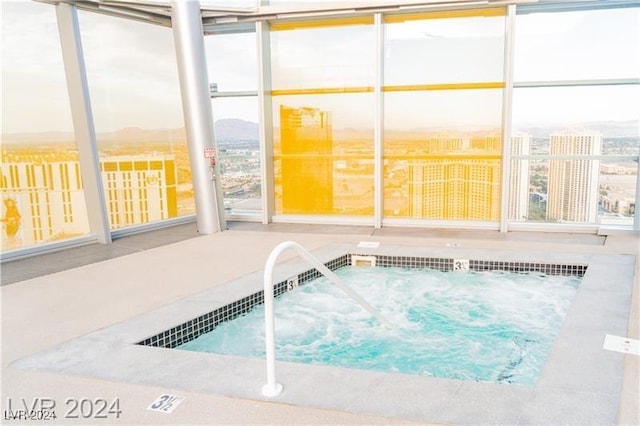view of pool with an in-ground hot tub and a mountain view