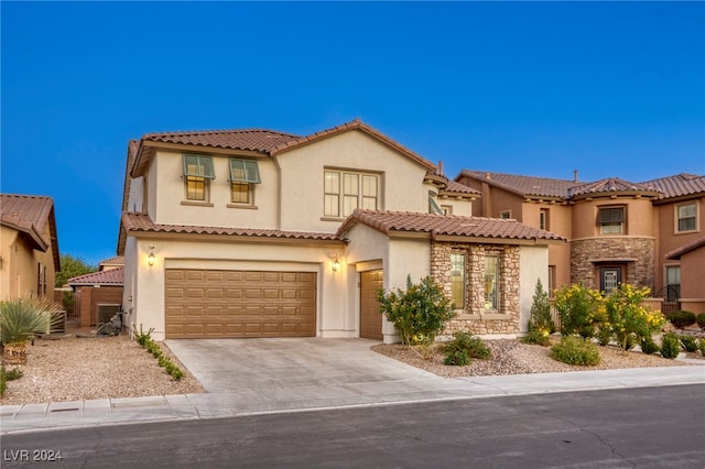 mediterranean / spanish home featuring a garage