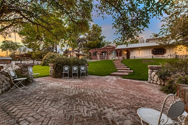 exterior space featuring a lawn and a patio