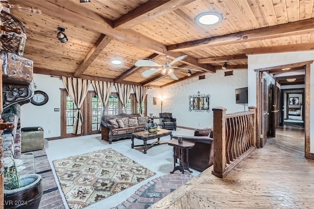 living room featuring ceiling fan, lofted ceiling with beams, and wooden ceiling