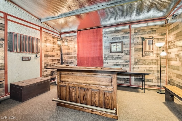 bar with carpet floors and wooden walls