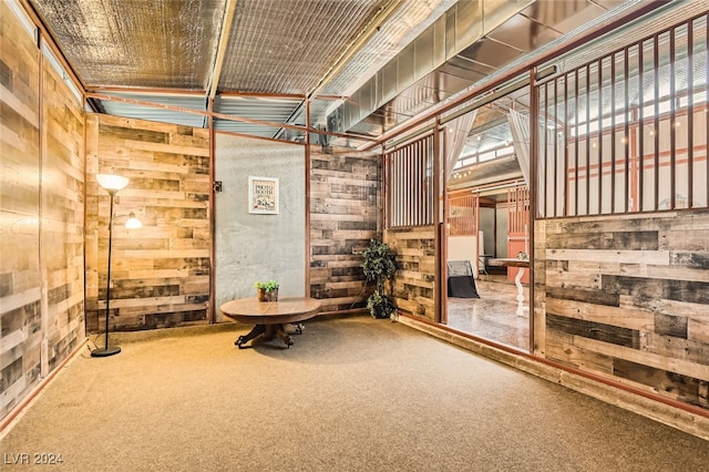 interior space with wooden walls and carpet floors