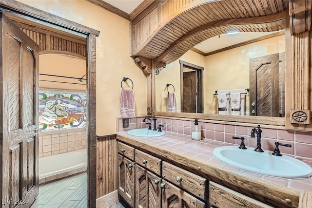 bathroom featuring ornamental molding, backsplash, and vanity