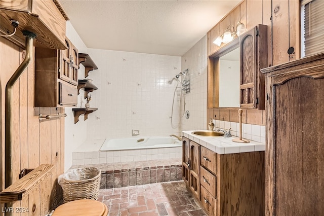 full bathroom featuring decorative backsplash, tiled shower / bath combo, vanity, and toilet