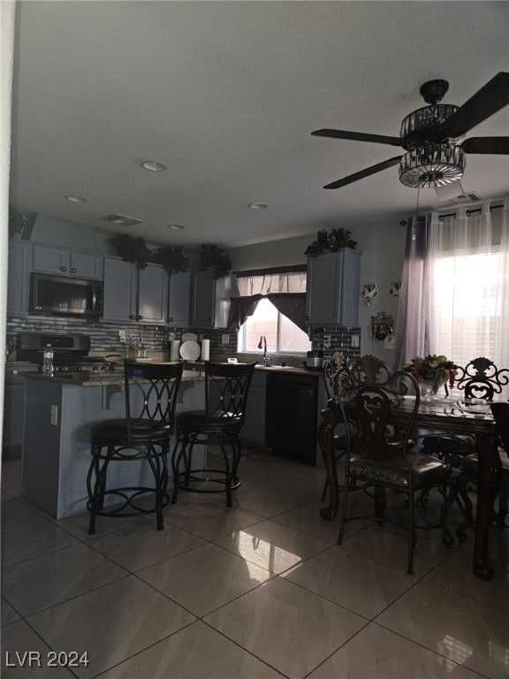 tiled dining space with ceiling fan