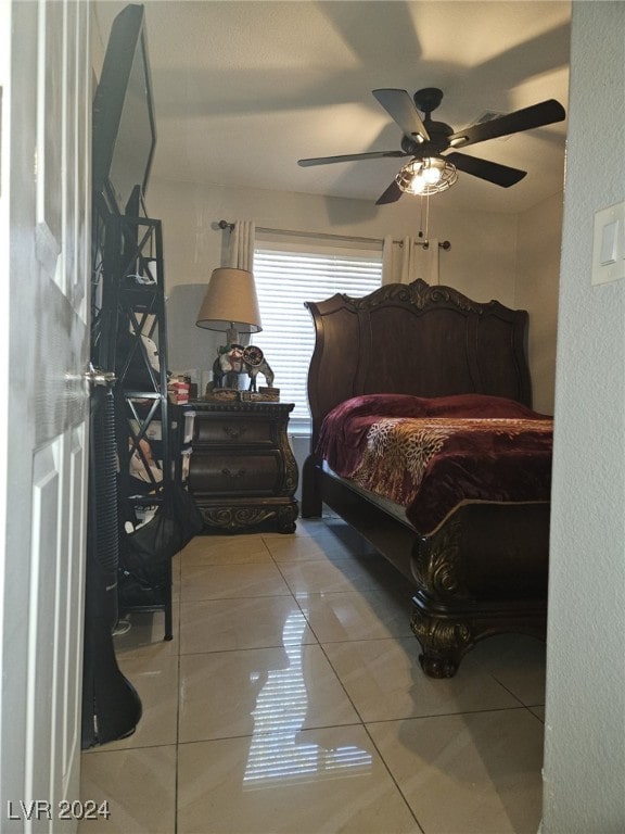 bedroom featuring tile patterned floors and ceiling fan