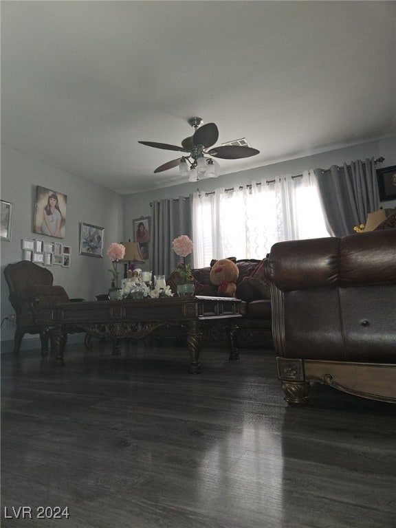 living room featuring ceiling fan and dark hardwood / wood-style flooring