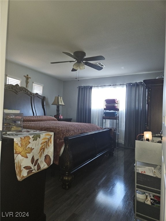 bedroom with ceiling fan, dark hardwood / wood-style floors, and multiple windows