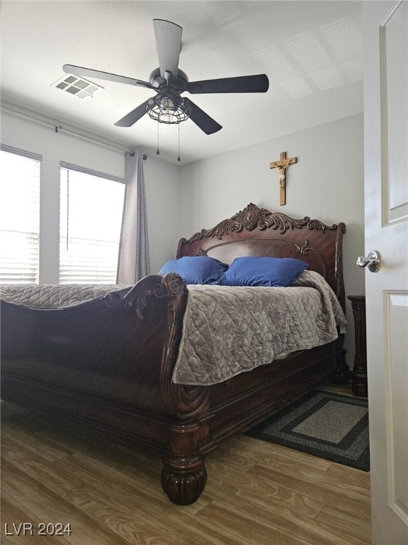 bedroom with ceiling fan and wood-type flooring