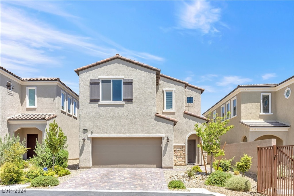 mediterranean / spanish house featuring a garage