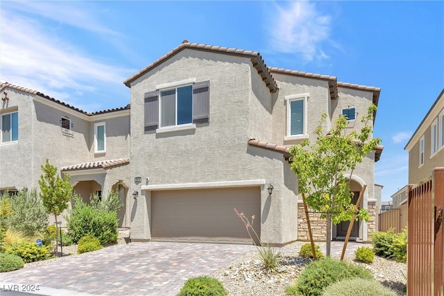 mediterranean / spanish-style home with a garage