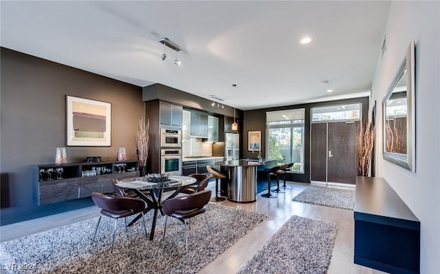 dining area featuring light hardwood / wood-style flooring and sink