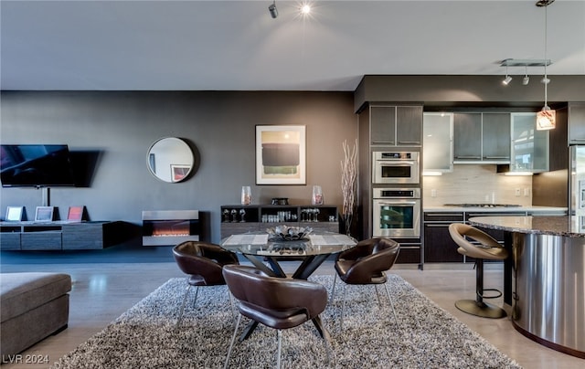 living room featuring a fireplace and track lighting