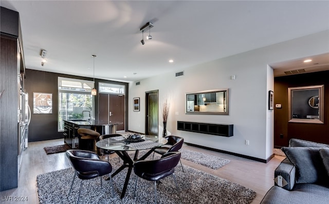 dining area featuring sink and light hardwood / wood-style flooring