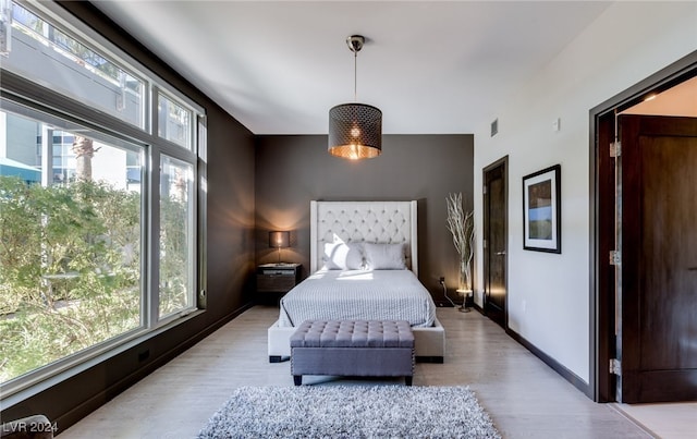 bedroom featuring light wood-type flooring and multiple windows