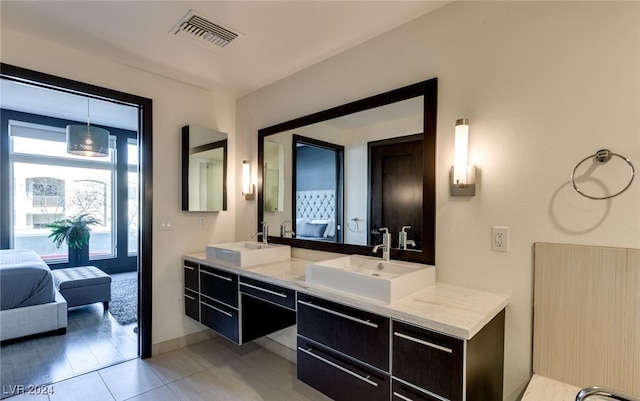 bathroom with tile patterned flooring and vanity