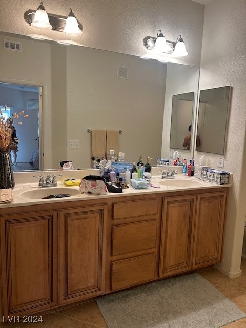 bathroom with tile patterned floors, vanity, and a textured ceiling