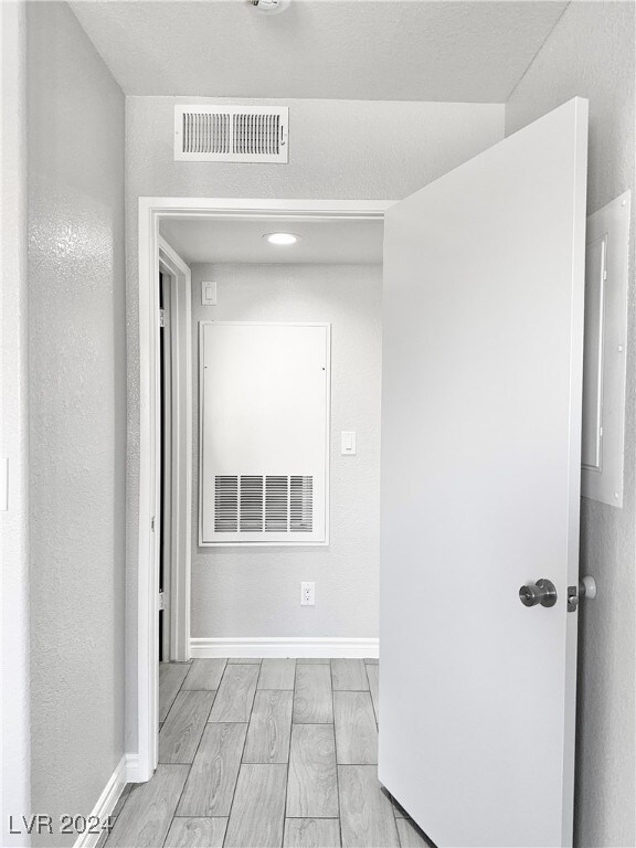 hallway with light hardwood / wood-style flooring