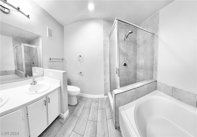 full bathroom featuring plus walk in shower, a textured ceiling, toilet, vanity, and hardwood / wood-style flooring