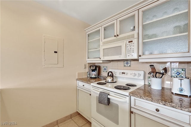 kitchen with white appliances, electric panel, backsplash, and light tile patterned floors