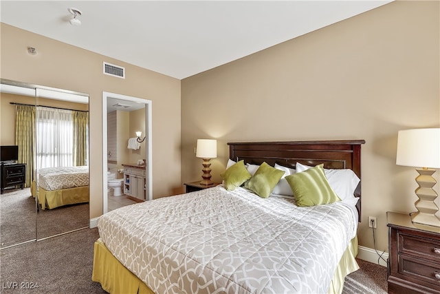 bedroom featuring a closet, connected bathroom, and carpet